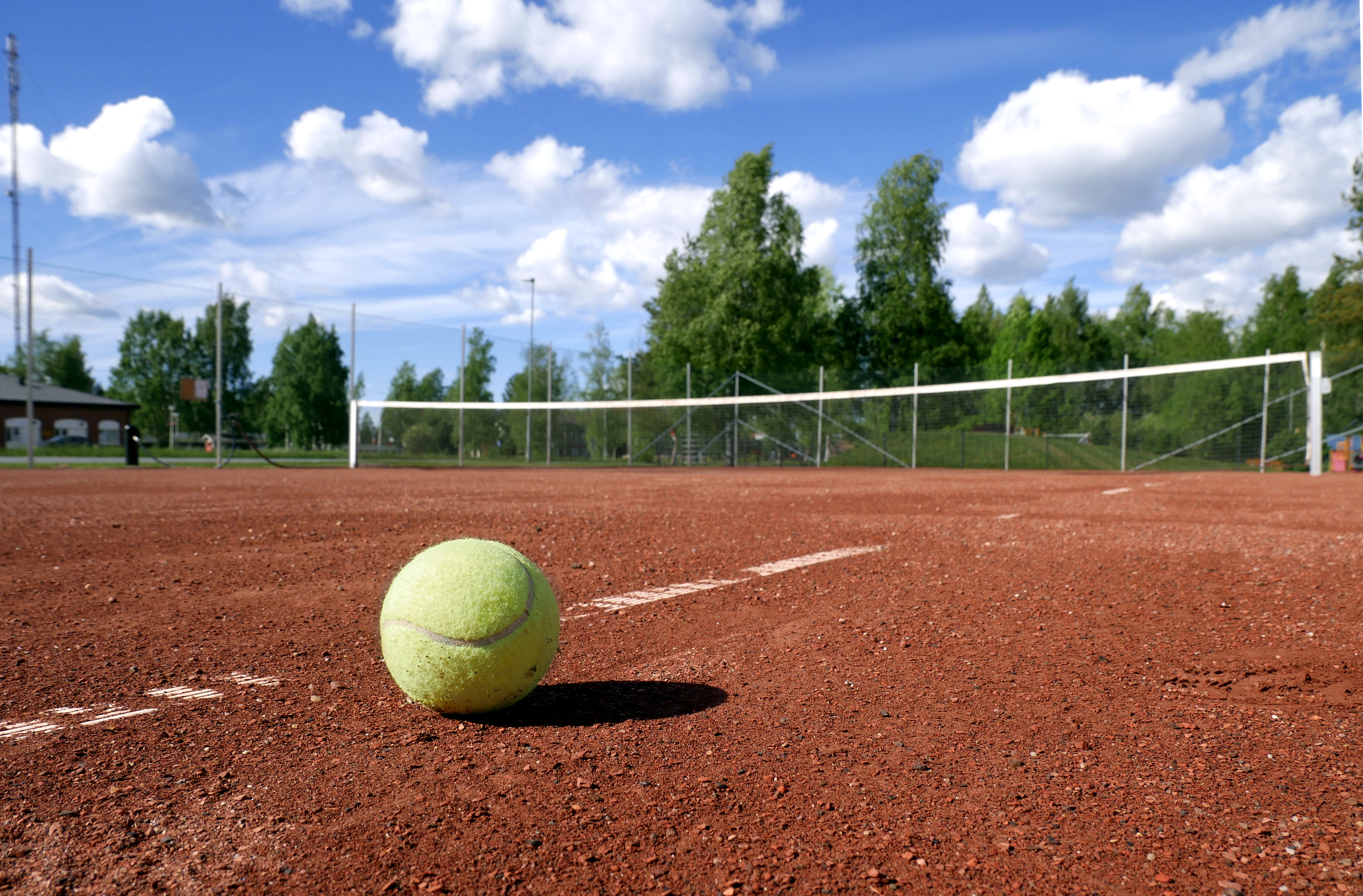 Tennis ball on a clay court
